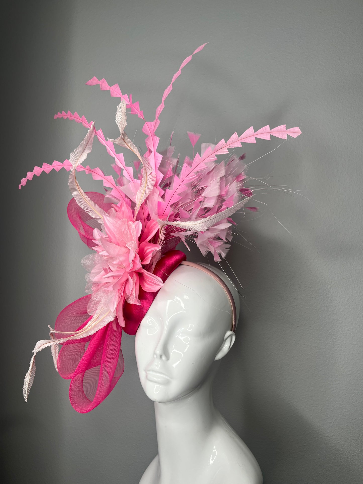 Bold Pink Statement Fascinator Hat with Floral and Feather Accents